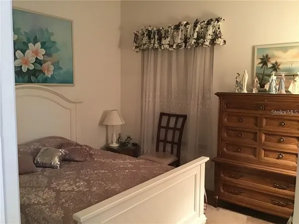 a bedroom with a bed and a dresser