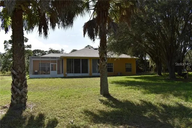 a view of a house with a backyard