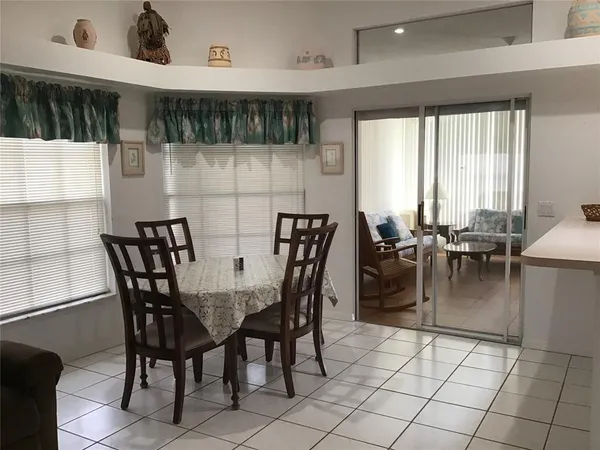 a dining area with furniture and a large window