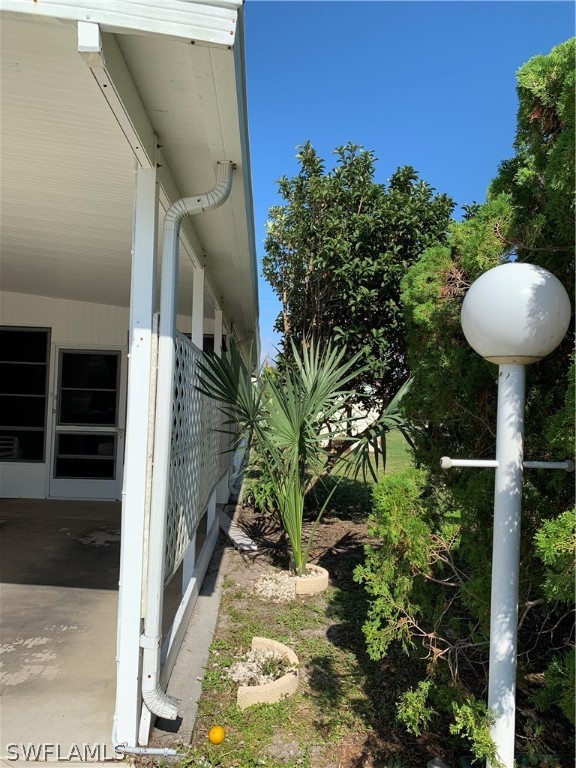 7680 Helen Road Bokeelia, FL 33922 - Photo 1 of 11 a view of a balcony with table and chairs and potted plants
