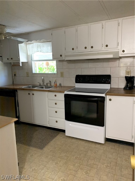 7680 Helen Road Bokeelia, FL 33922 - Photo 4 of 11 a kitchen with granite countertop white cabinets and white stainless steel appliances