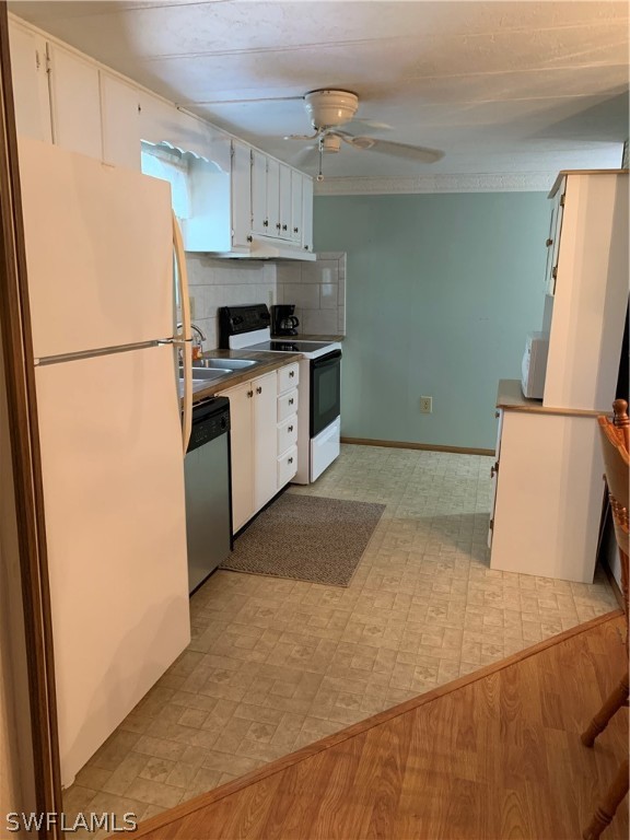 7680 Helen Road Bokeelia, FL 33922 - Photo 5 of 11 a kitchen with a refrigerator and a stove