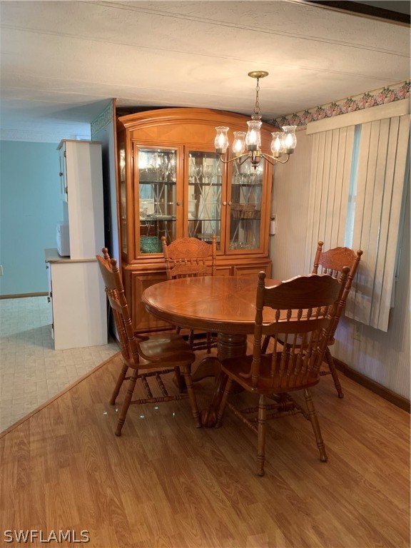 7680 Helen Road Bokeelia, FL 33922 - Photo 6 of 11 a view of a dining room with furniture window and wooden floor