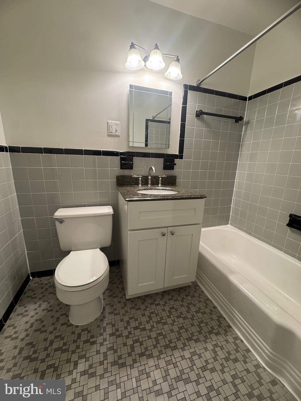 1510 North Rolfe Street, Unit 4 Arlington, VA 22209 - Photo 8 of 9 a bathroom with a toilet a sink a mirror and bathtub
