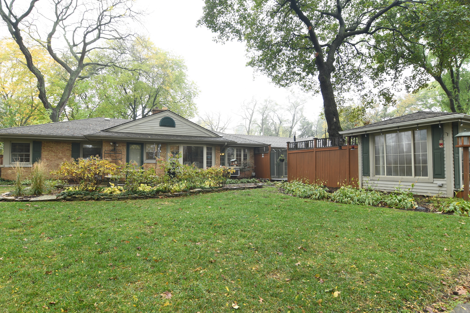 909 Warrenville Road Wheaton, IL 60189 - Photo 18 of 22 a front view of a house with garden