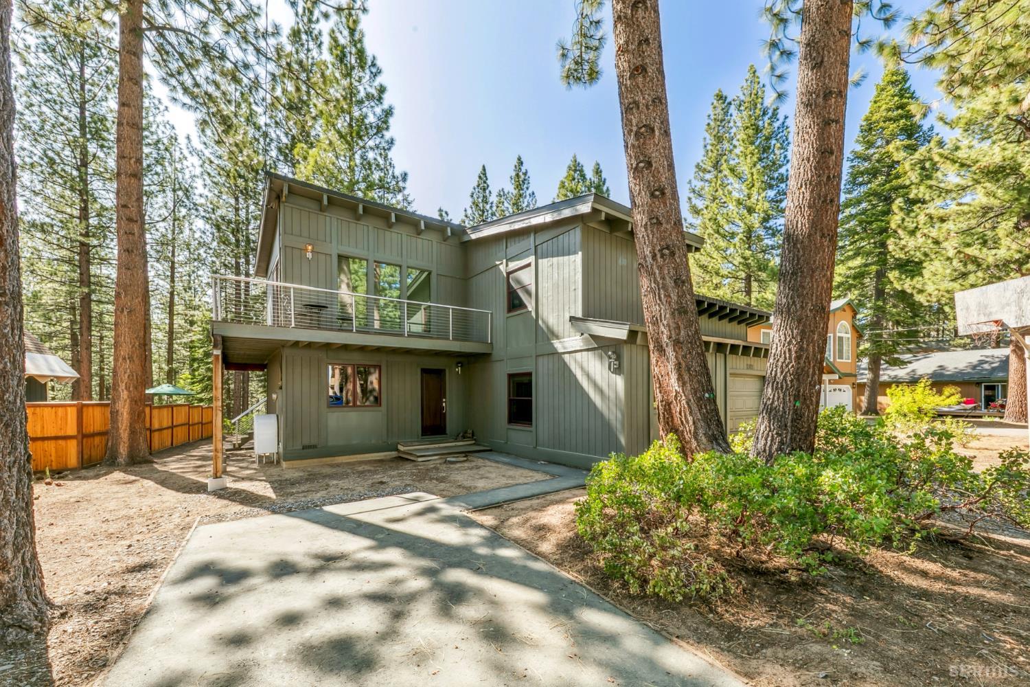 a view of a house with a small yard and potted plants