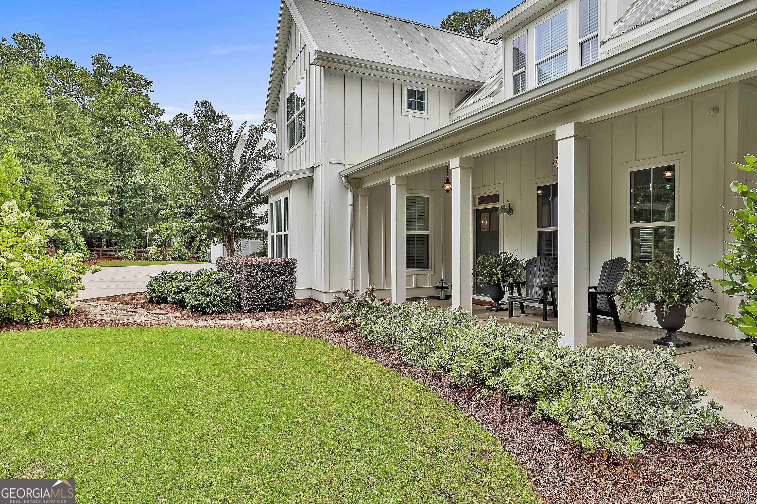 49 Standing Rock Road Senoia, GA 30276 - Photo 11 of 92 a view of a house with brick walls and a yard with plants