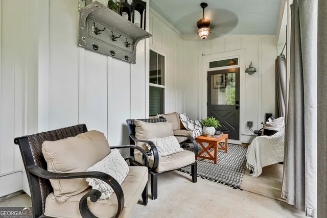 a kitchen with stainless steel appliances kitchen island granite countertop a table chairs in it and white cabinets