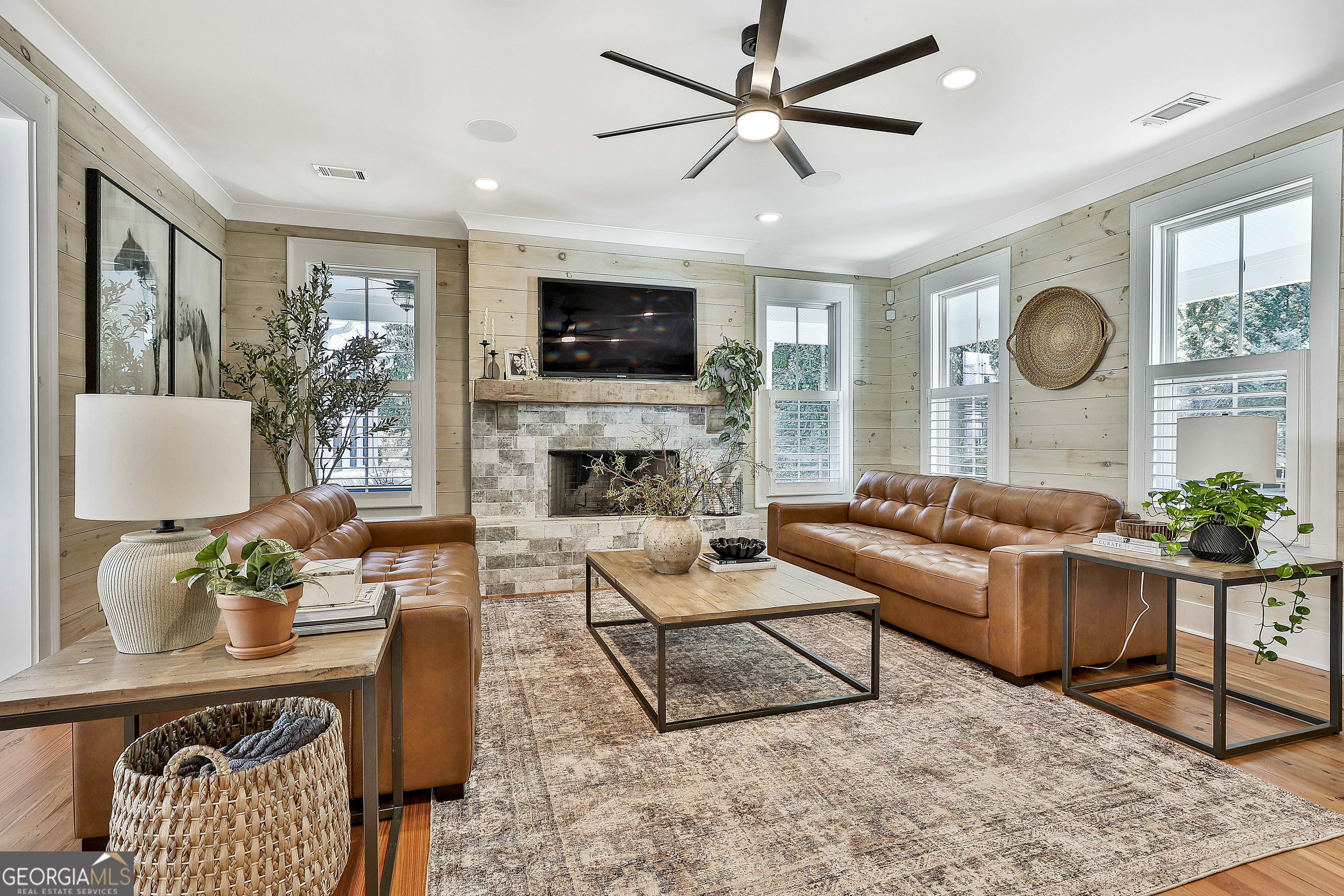 49 Standing Rock Road Senoia, GA 30276 - Photo 25 of 92 a living room with furniture a flat screen tv and a fireplace