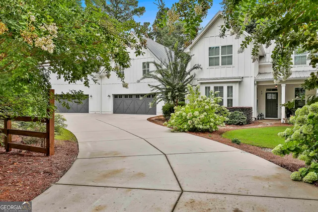 a view of house with yard and green space
