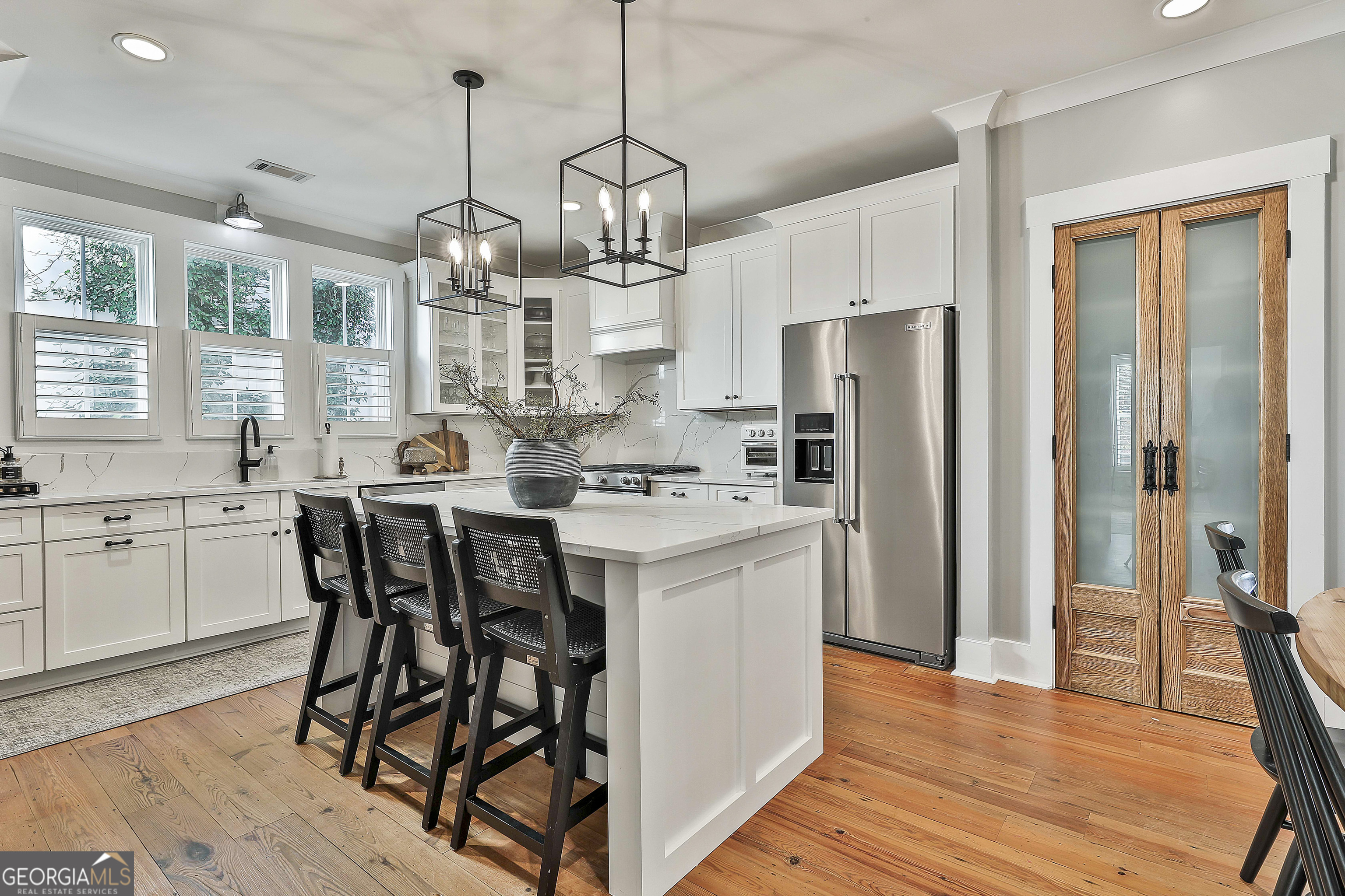 49 Standing Rock Road Senoia, GA 30276 - Photo 31 of 92 a kitchen with stainless steel appliances a dining table chairs a refrigerator and cabinets