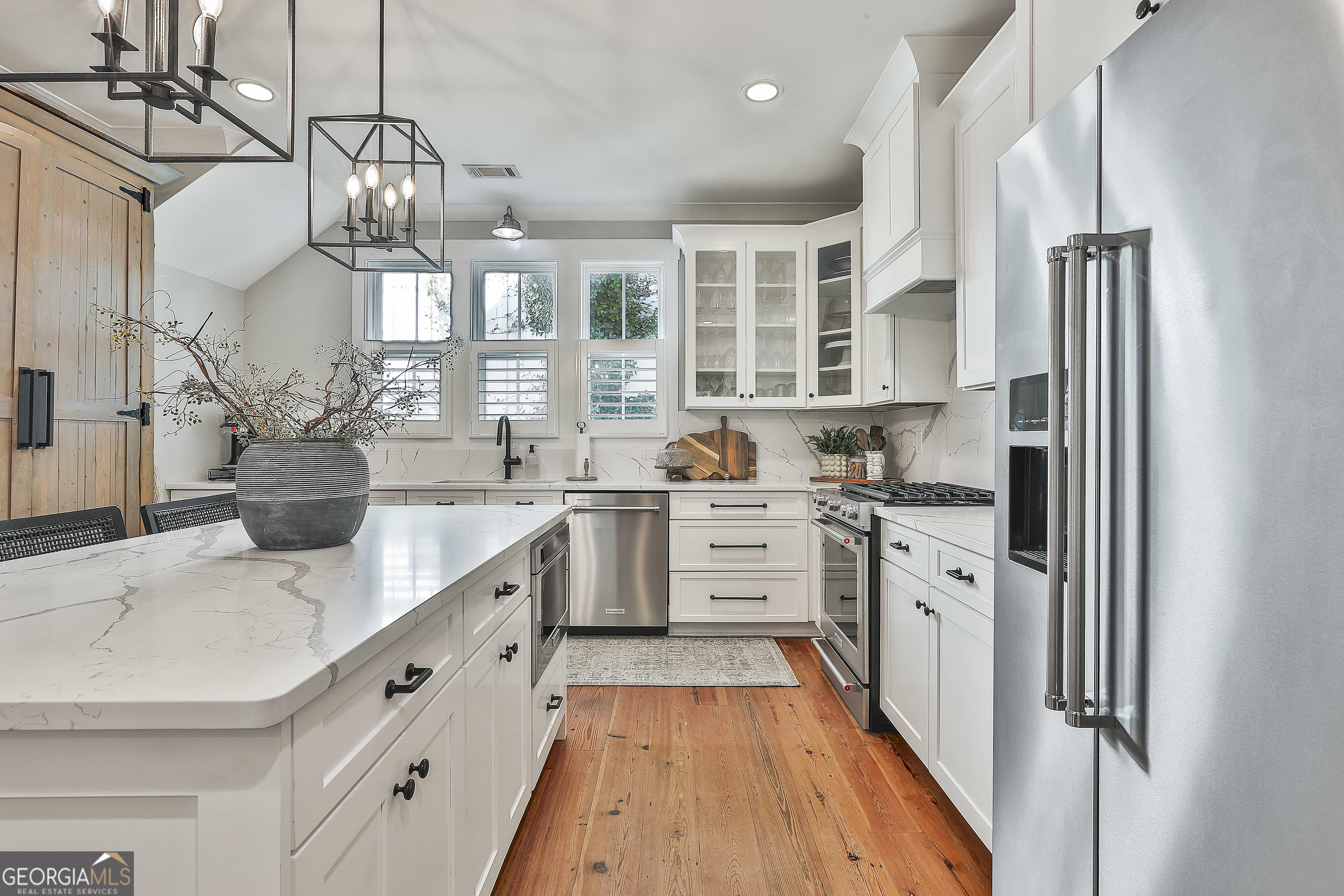 49 Standing Rock Road Senoia, GA 30276 - Photo 32 of 92 a kitchen with stainless steel appliances kitchen island granite countertop a sink stove and refrigerator