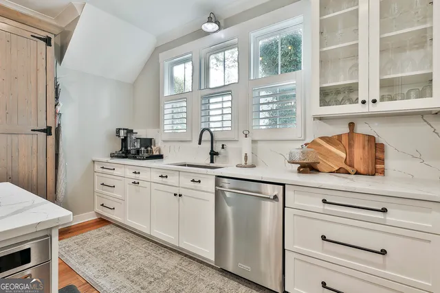 a view of a bedroom with a bed and a window