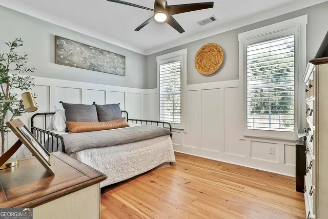 a front view of a house with a garden and outdoor seating