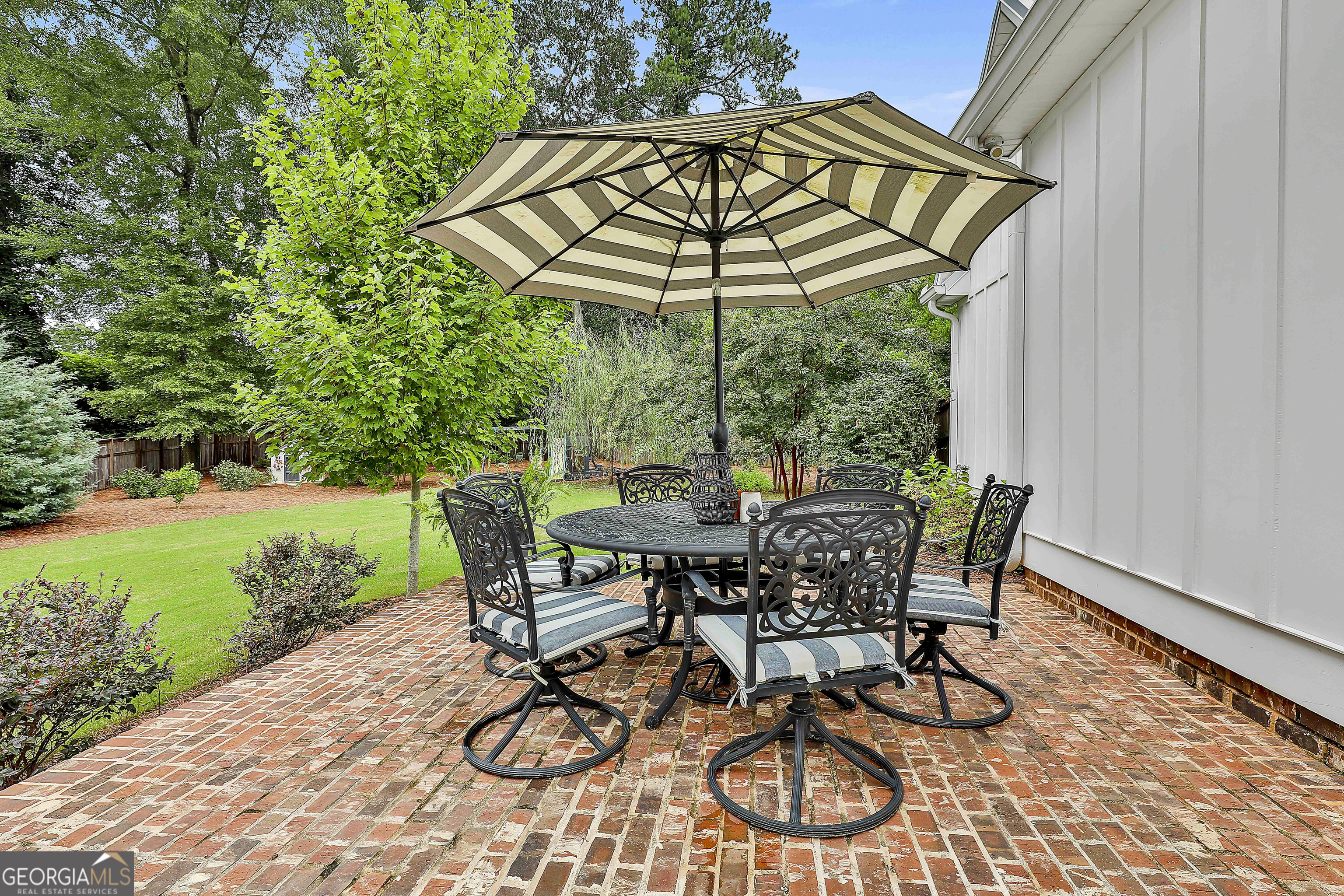 49 Standing Rock Road Senoia, GA 30276 - Photo 83 of 92 a view of a patio with table and chairs under an umbrella