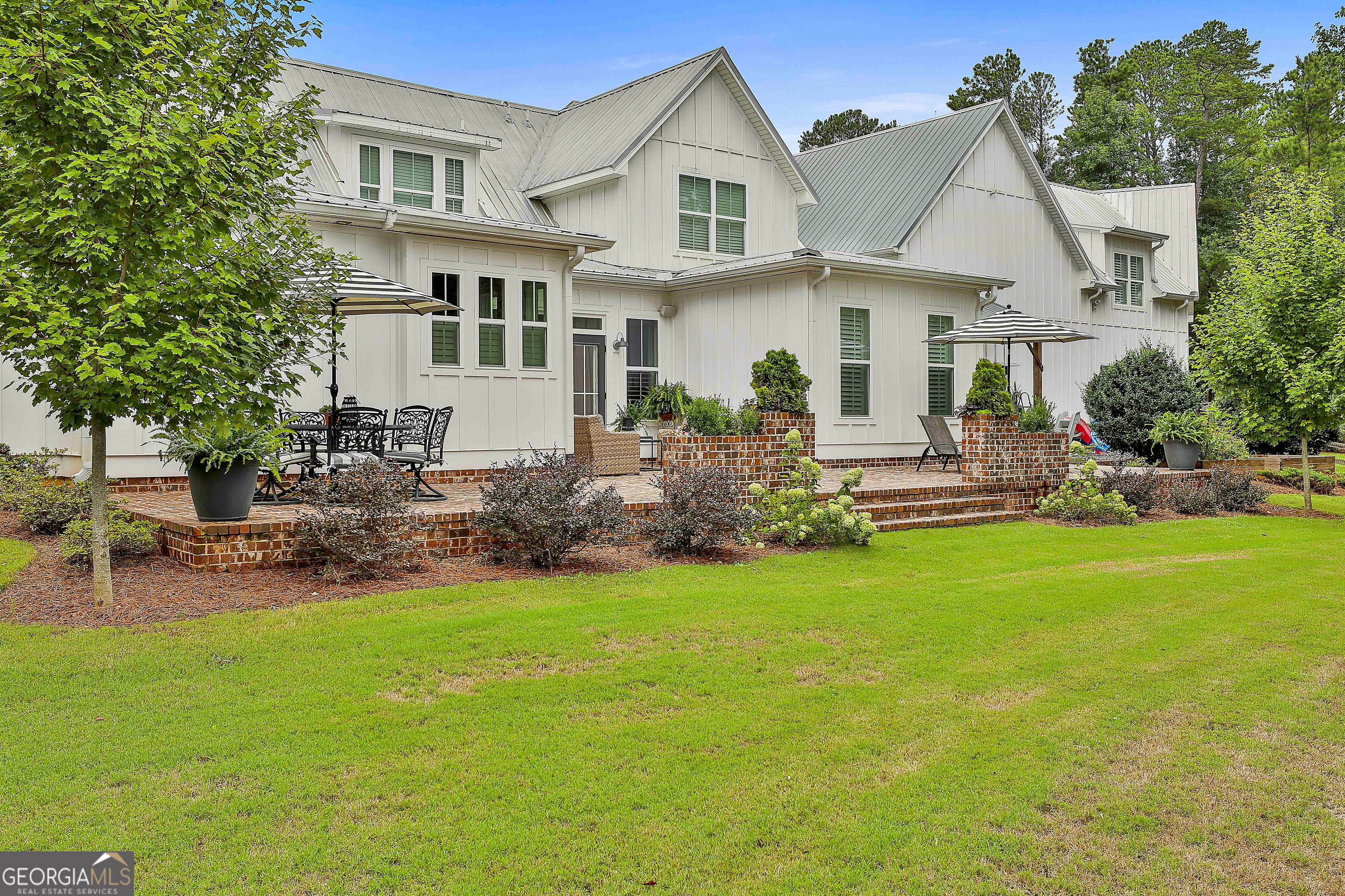 49 Standing Rock Road Senoia, GA 30276 - Photo 89 of 92 a front view of a house with a garden and outdoor seating