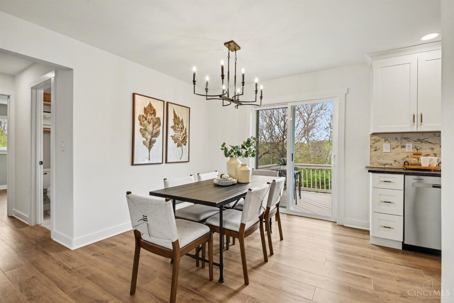 7230 Barret Road West Chester, OH 45069 - Photo 9 of 50 Dining room has modern black chandelier and nature views out of the new 5' Pella sliding door.
