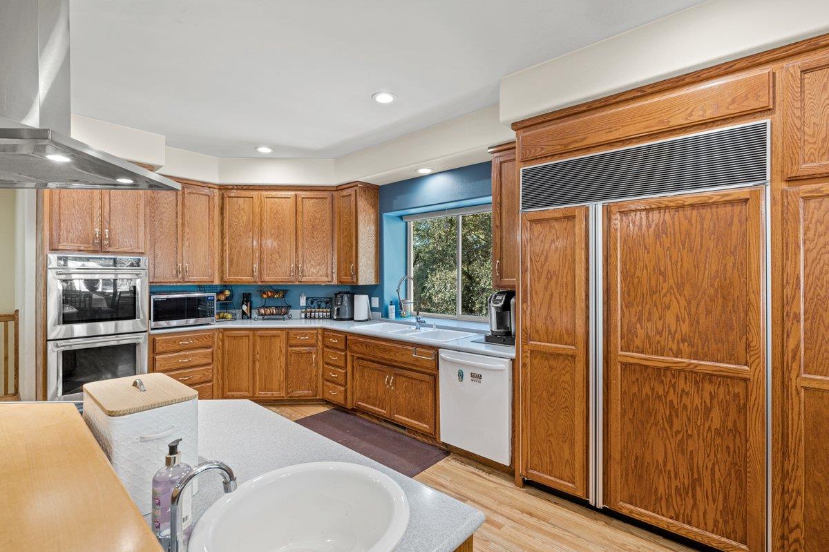 1144 Boole Road Applegate, CA 95703 - Photo 34 of 65 a kitchen with a refrigerator a sink and cabinets