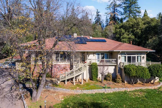 a front view of house with yard and green space