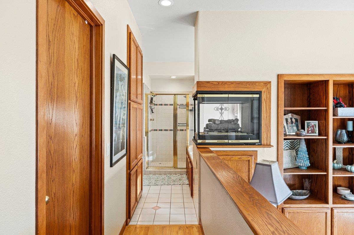 1144 Boole Road Applegate, CA 95703 - Photo 43 of 65 a hallway with a large window and book shelf