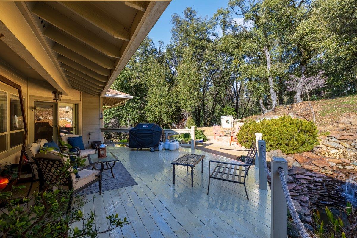 1144 Boole Road Applegate, CA 95703 - Photo 10 of 65 a view of a patio with table and chairs potted plants with wooden floor and fence