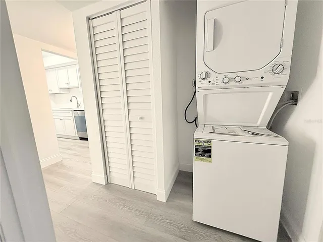 an entryway with a washer and dryer