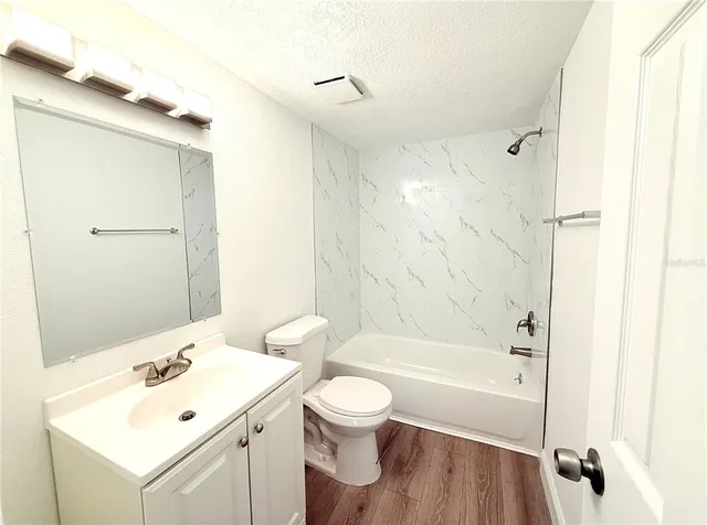 a bathroom with a white sink a toilet and a bathtub