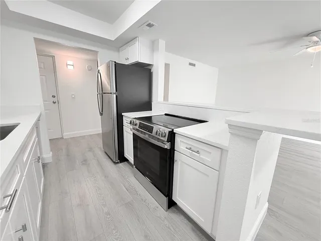 a kitchen with stainless steel appliances a refrigerator and a stove