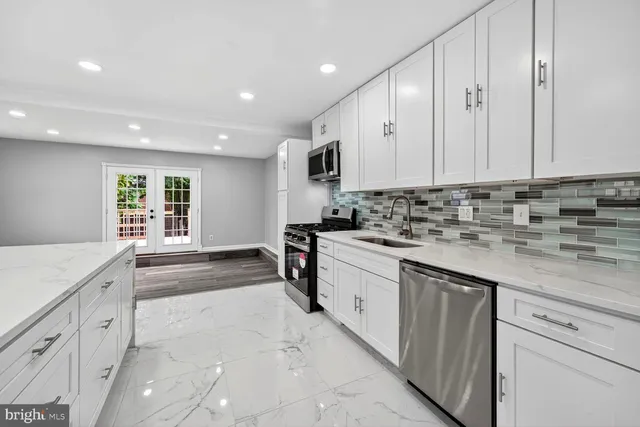 a kitchen with granite countertop a sink and cabinets