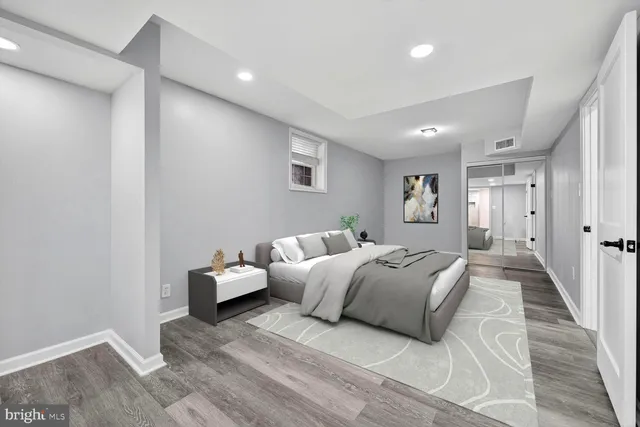 a spacious bedroom with a bed and a couch