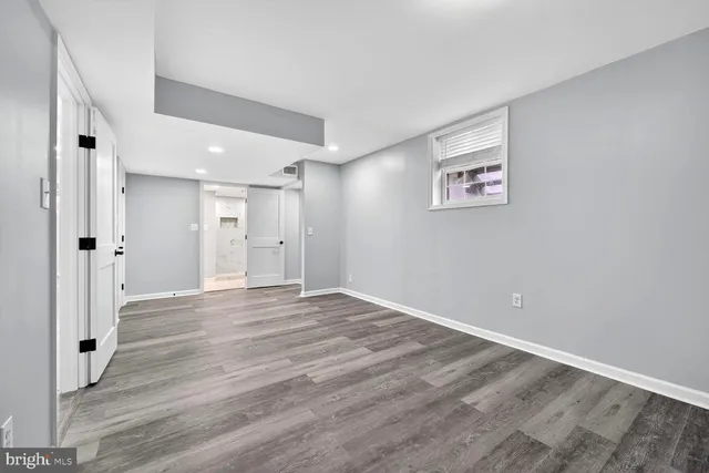 a view of an empty room with wooden floor
