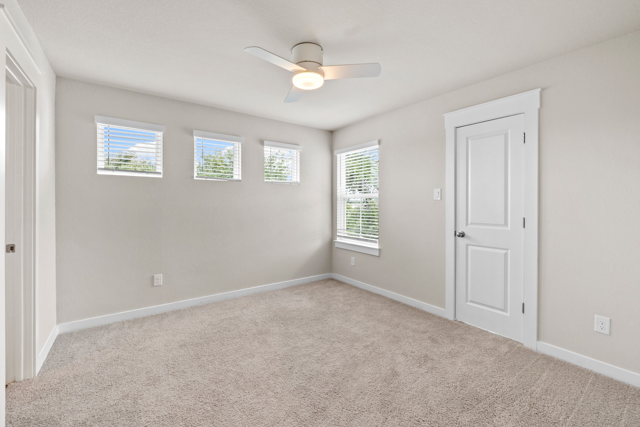 2251 Rocoso Trail Leander, TX 78641 - Photo 22 of 34 Plentiful window light fills this bedroom featuring neutral-toned carpeting.