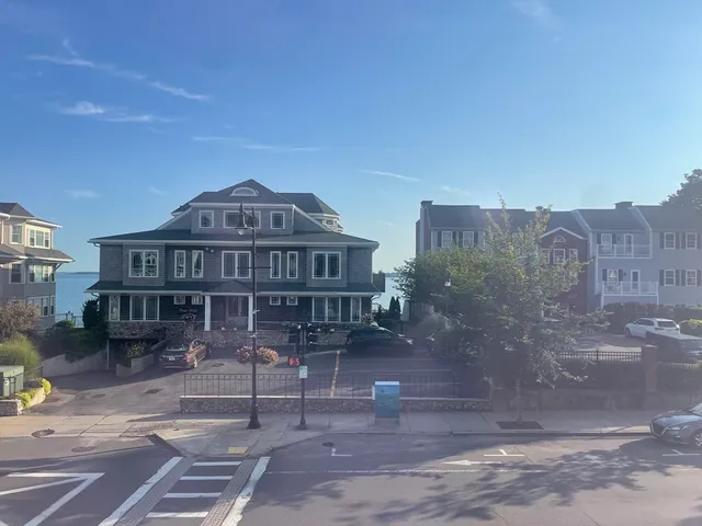 a view of a big house with a yard