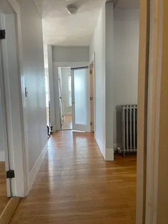 a view of a hallway with hallway and wooden floor