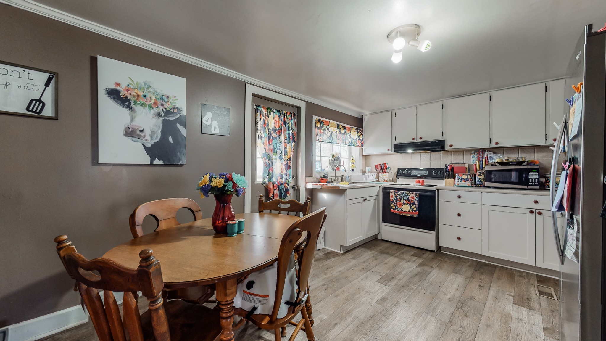 8 Layman Road Elora, TN 37328 - Photo 8 of 34 a kitchen with a table chairs a stove a dining table and chairs