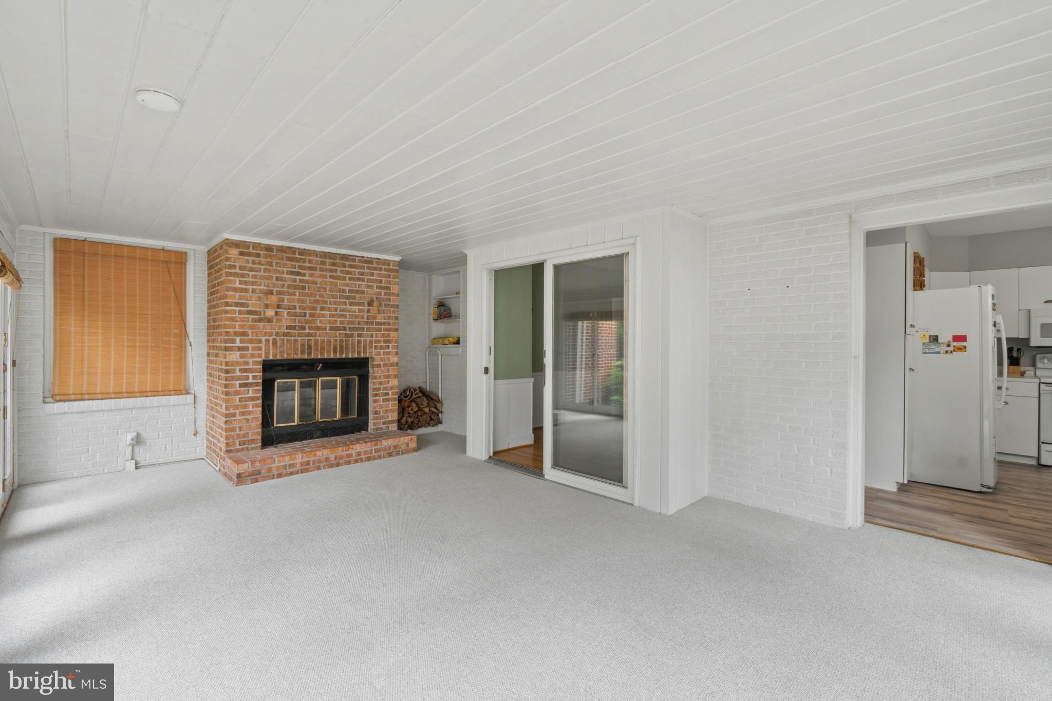 909 Weatherbee Road Towson, MD 21286 - Photo 19 of 51 a view of a livingroom with a fireplace and window