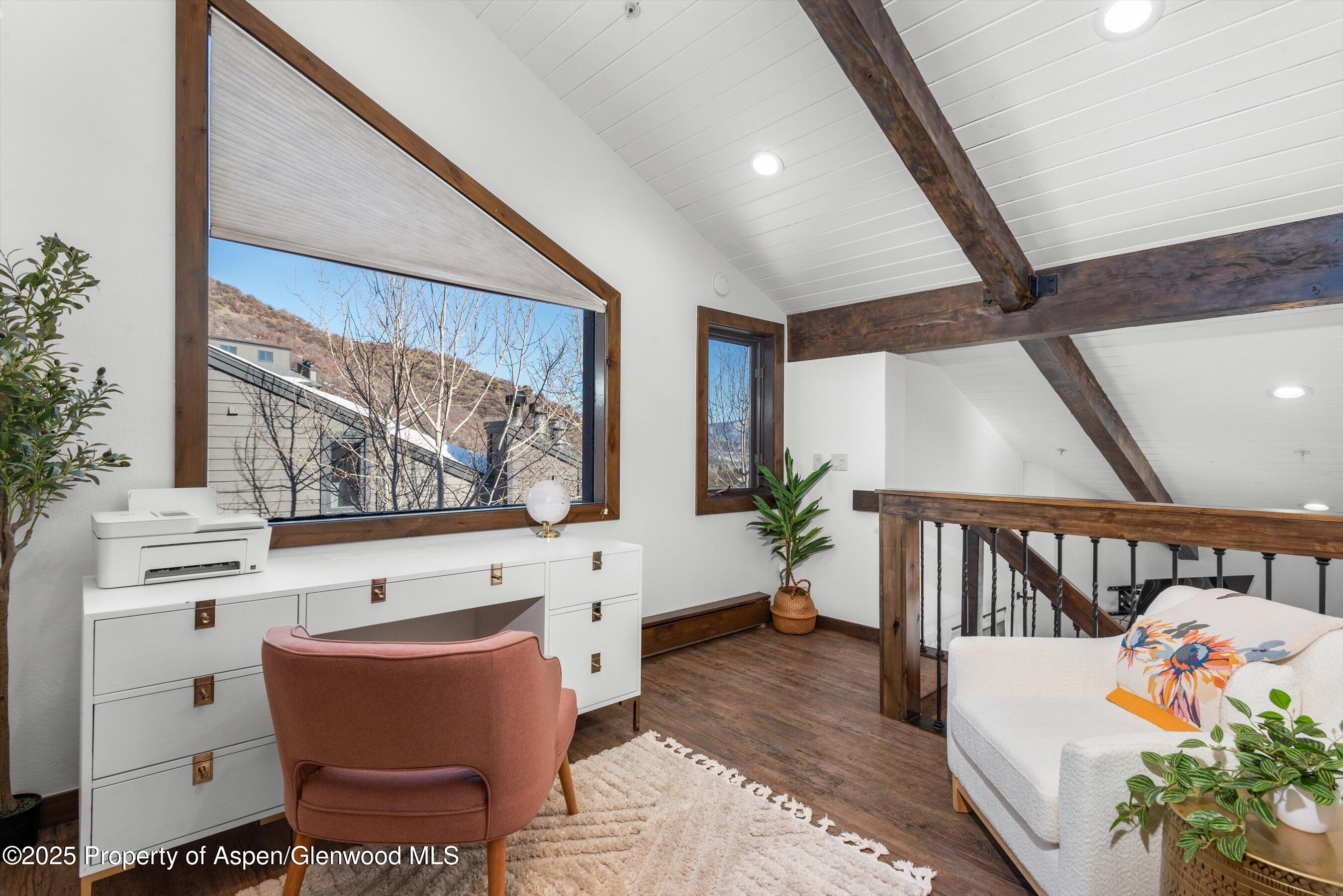 55 Upper Woodbridge Road, Unit J5 Snowmass Village, CO 81615 - Photo 14 of 32 a living room with furniture and a large window