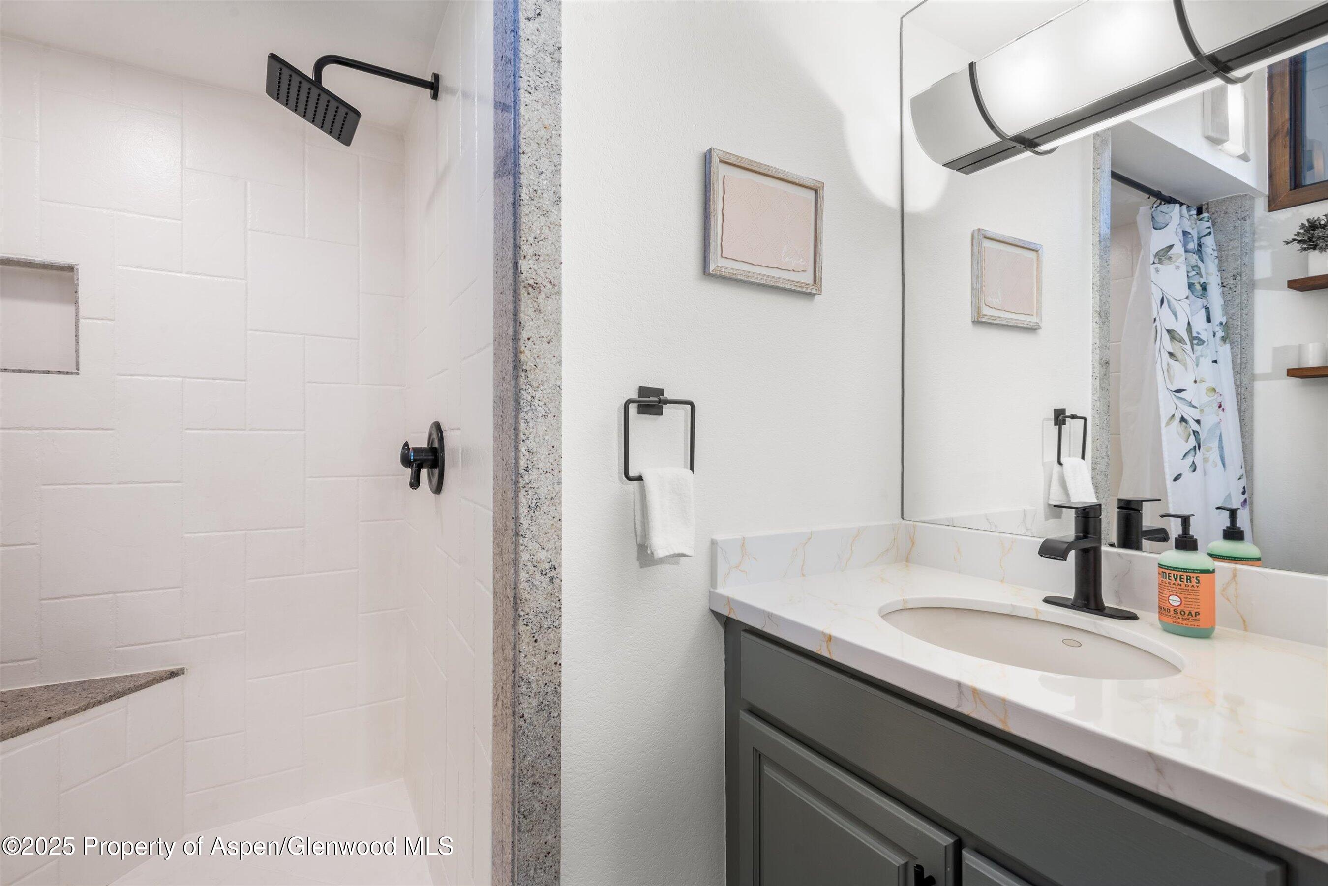55 Upper Woodbridge Road, Unit J5 Snowmass Village, CO 81615 - Photo 16 of 32 a bathroom with a sink and mirror