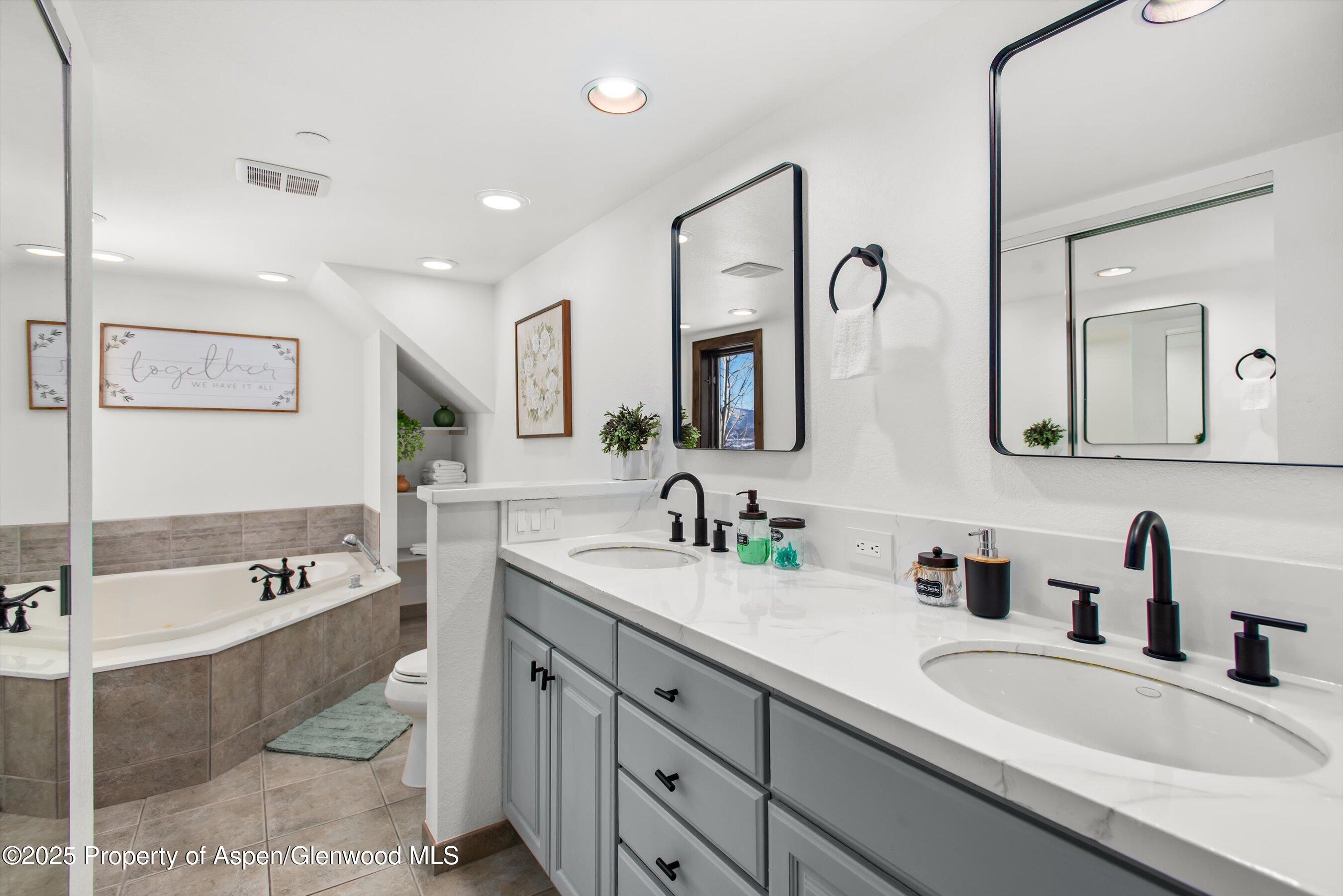55 Upper Woodbridge Road, Unit J5 Snowmass Village, CO 81615 - Photo 18 of 32 a spacious bathroom with a double vanity sink mirror double and bathtub