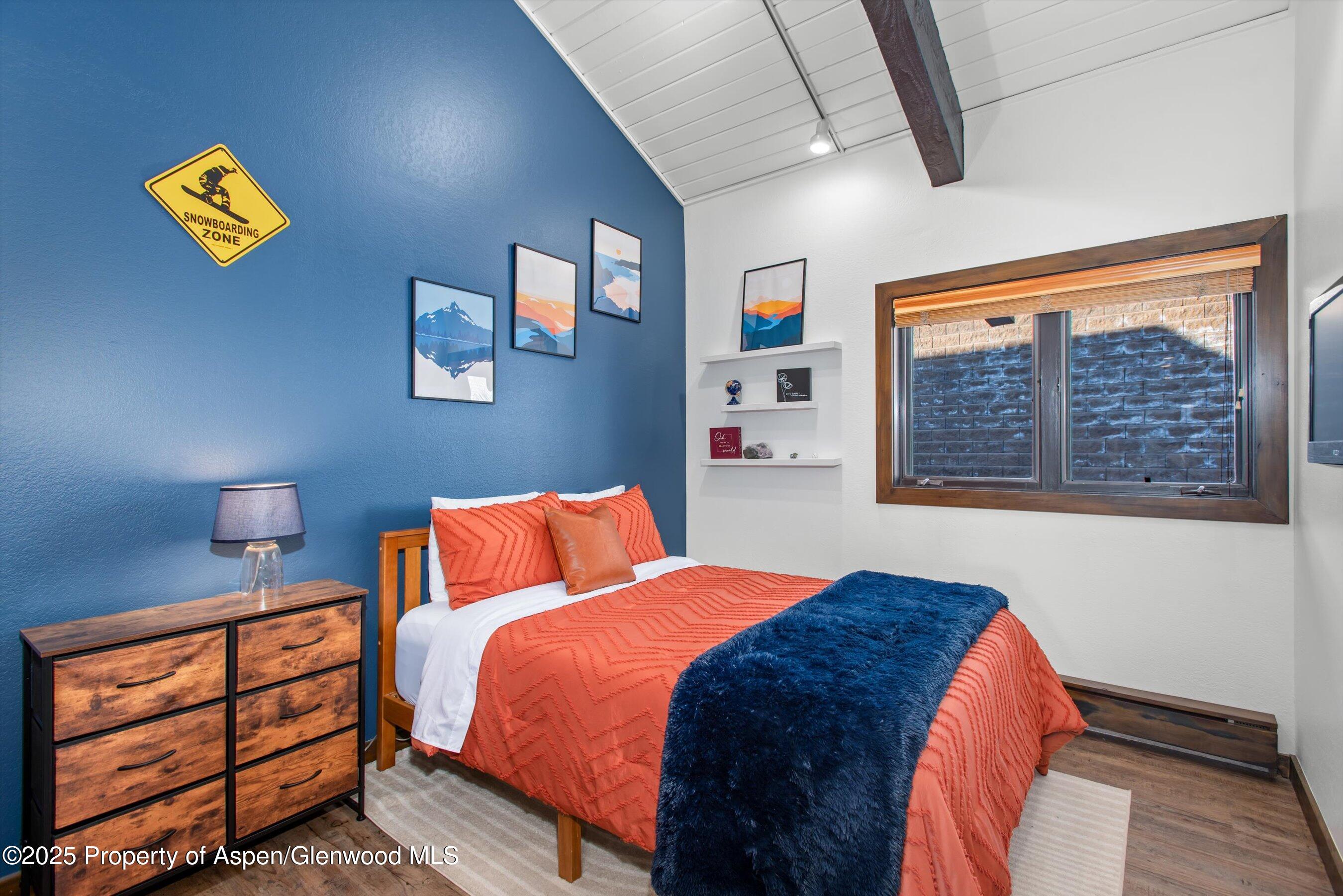 55 Upper Woodbridge Road, Unit J5 Snowmass Village, CO 81615 - Photo 19 of 32 a bedroom with a bed and a window