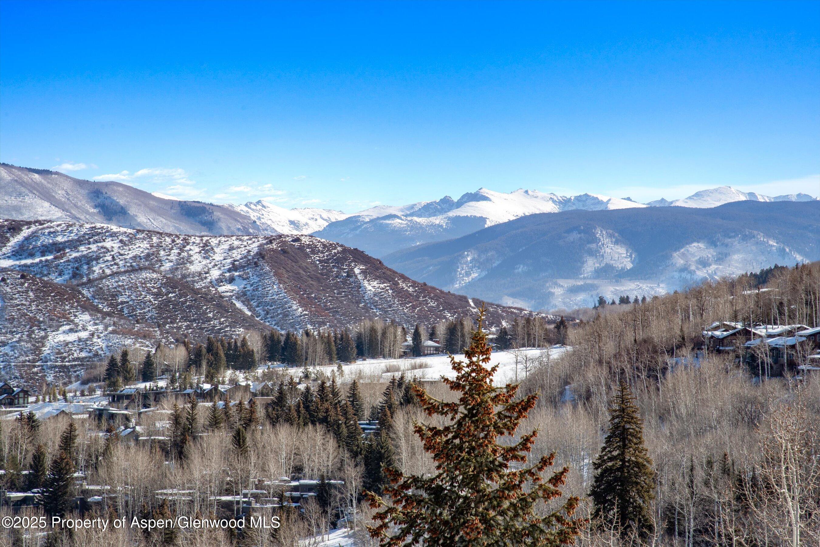 55 Upper Woodbridge Road, Unit J5 Snowmass Village, CO 81615 - Photo 2 of 32 a view of a town with mountains in the background