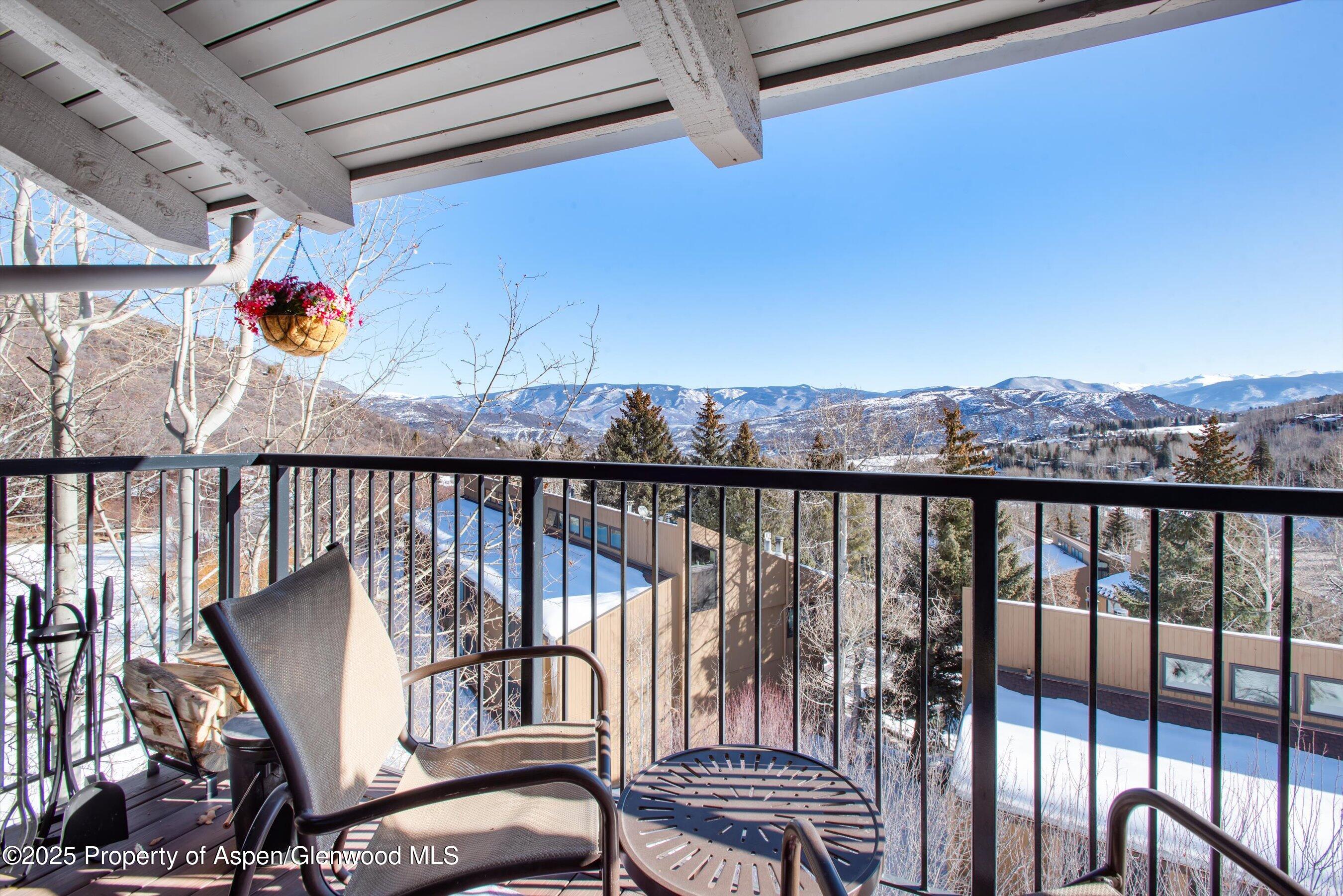 55 Upper Woodbridge Road, Unit J5 Snowmass Village, CO 81615 - Photo 24 of 32 a view of a chairs and table in the balcony