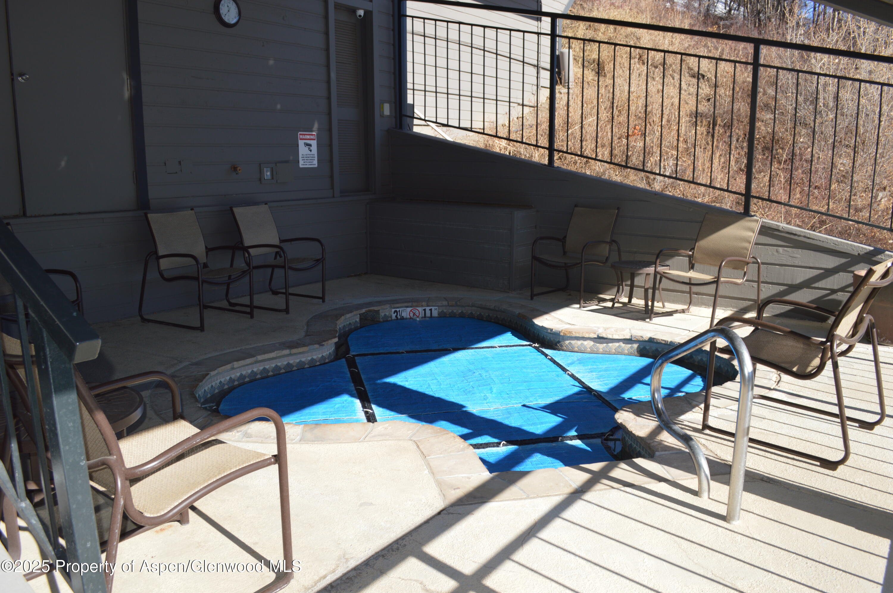 55 Upper Woodbridge Road, Unit J5 Snowmass Village, CO 81615 - Photo 27 of 32 a view of a patio with table and chairs with wooden floor