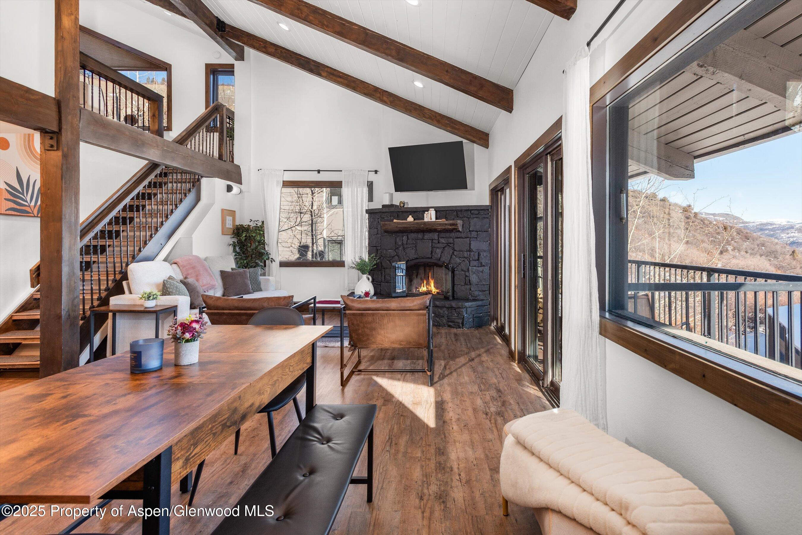 55 Upper Woodbridge Road, Unit J5 Snowmass Village, CO 81615 - Photo 7 of 32 a living room with fireplace furniture and a large window