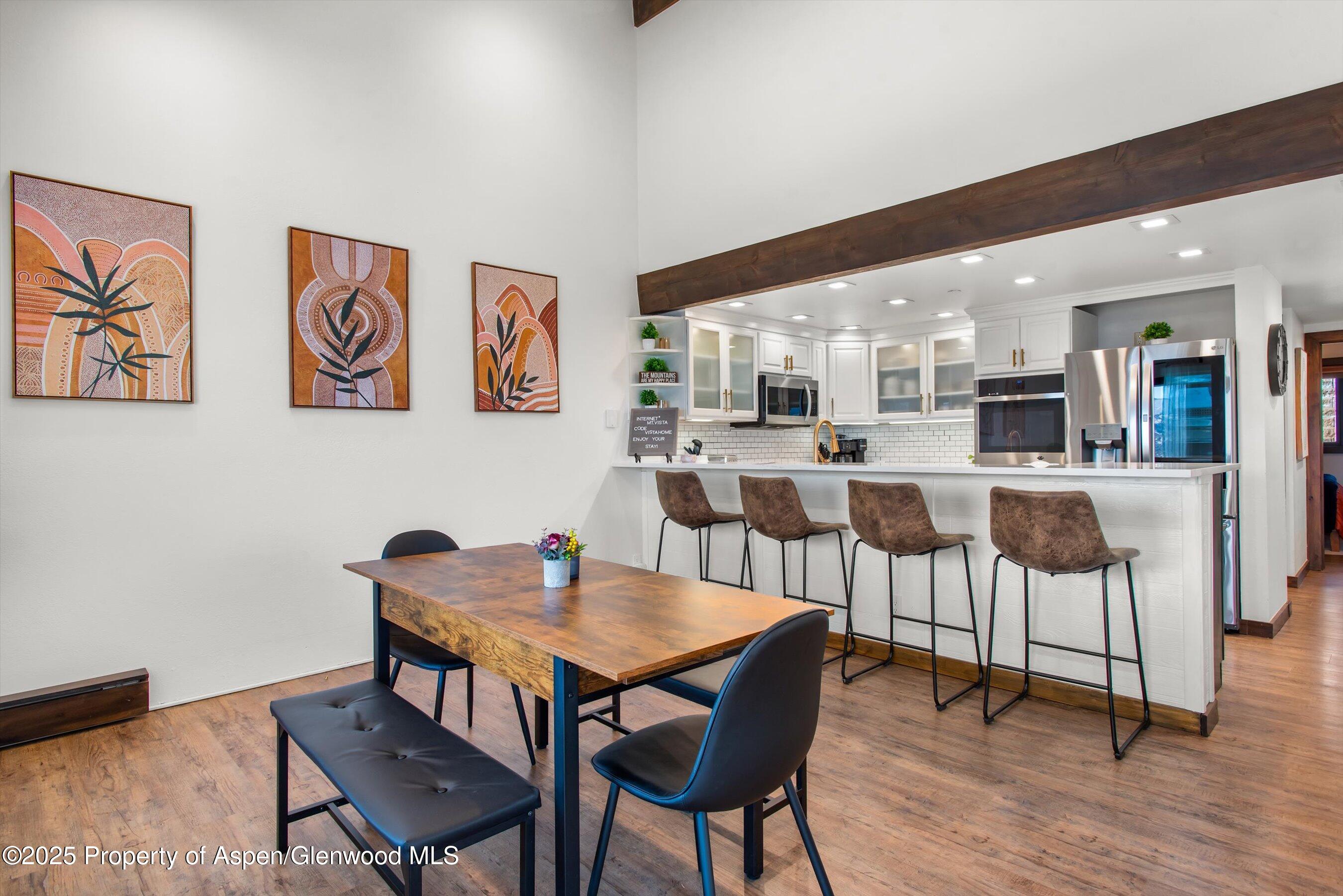 55 Upper Woodbridge Road, Unit J5 Snowmass Village, CO 81615 - Photo 8 of 32 a view of a dining room with furniture and wooden floor