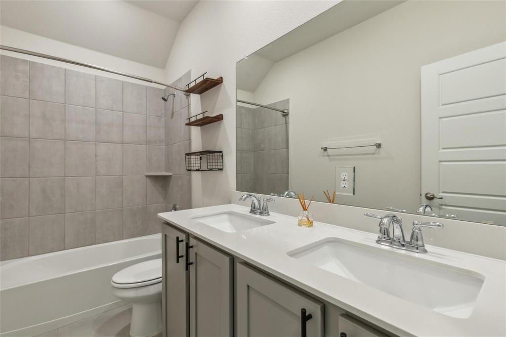 10314 Echo Brk Lane Aubrey, TX 76227 - Photo 11 of 21 Bathroom featuring double vanity and shower / bathtub combination