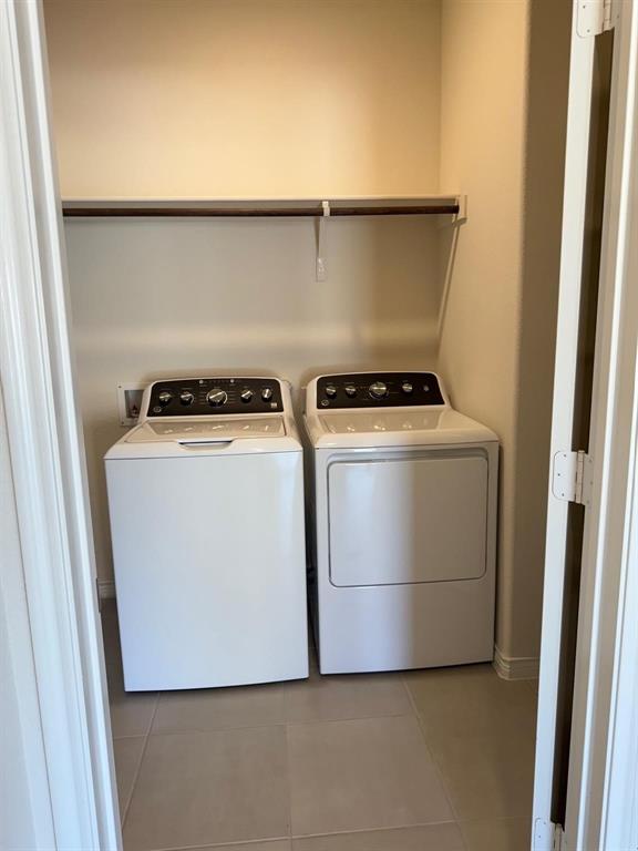 10314 Echo Brk Lane Aubrey, TX 76227 - Photo 12 of 21 Laundry room featuring light tile patterned flooring and washing machine and dryer