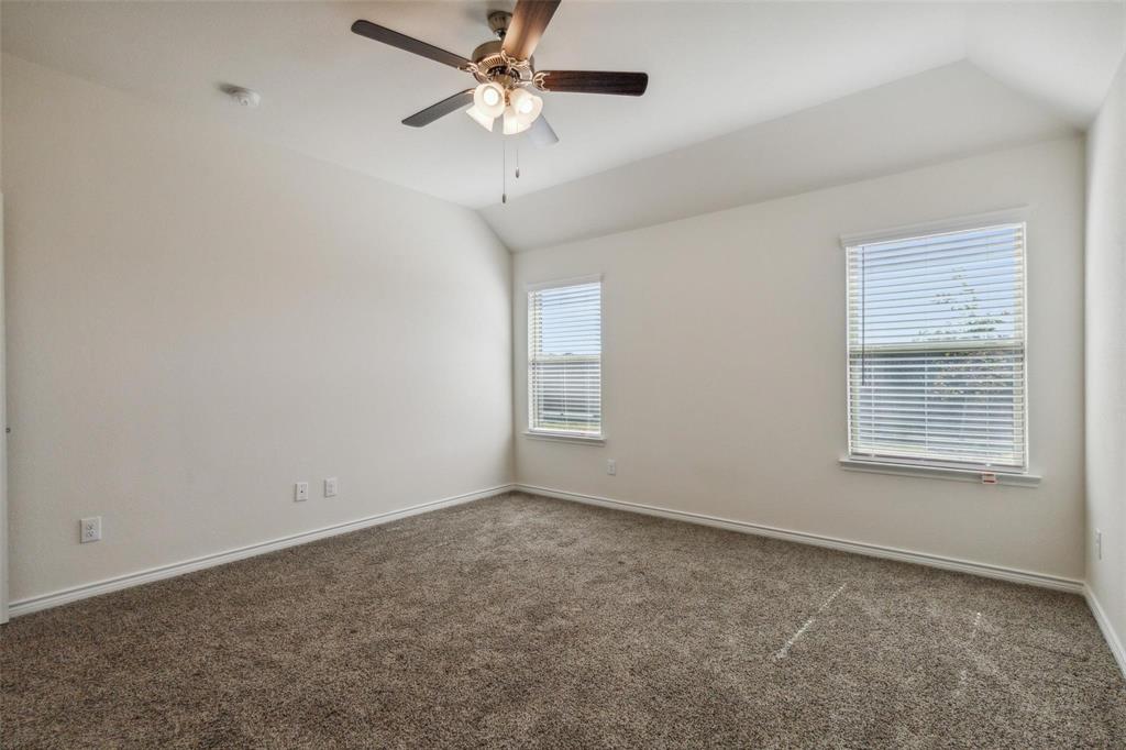 10314 Echo Brk Lane Aubrey, TX 76227 - Photo 18 of 21 Empty room with lofted ceiling, carpet floors, and a ceiling fan