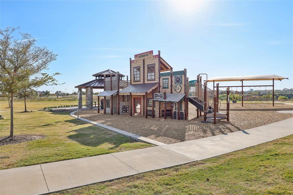10314 Echo Brk Lane Aubrey, TX 76227 - Photo 19 of 21 Community play area featuring a lawn