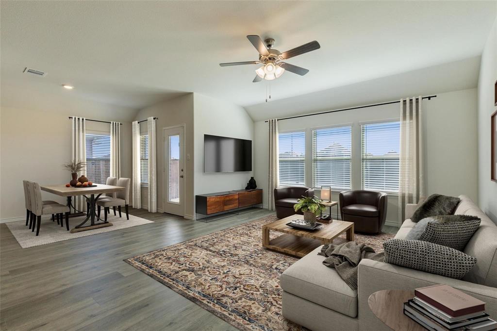 10314 Echo Brk Lane Aubrey, TX 76227 - Photo 4 of 21 Living area featuring wood finished floors, lofted ceiling, and ceiling fan